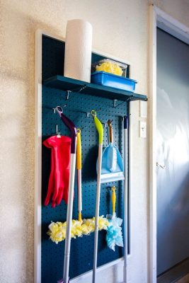 use Pegboard for brooms and mops